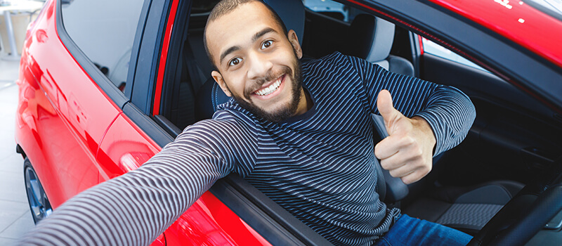 man smiling in car