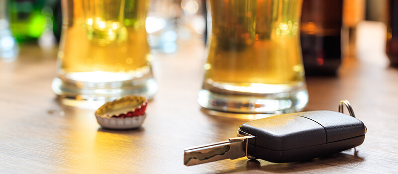 car keys with glass of alcohol