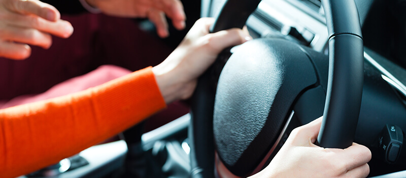 girls hands on steering wheel